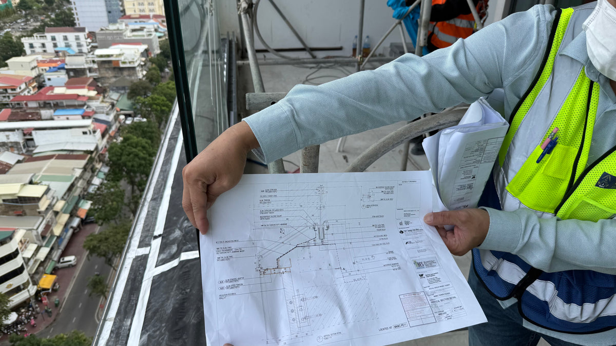 Façade engineer inspecting glass during curtain wall QAQC inspection
