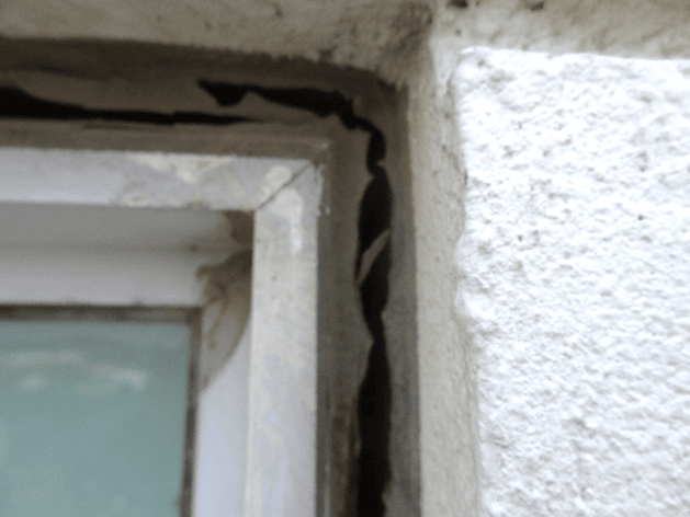 Damaged sealant joint around window frame showing potential façade water ingress
