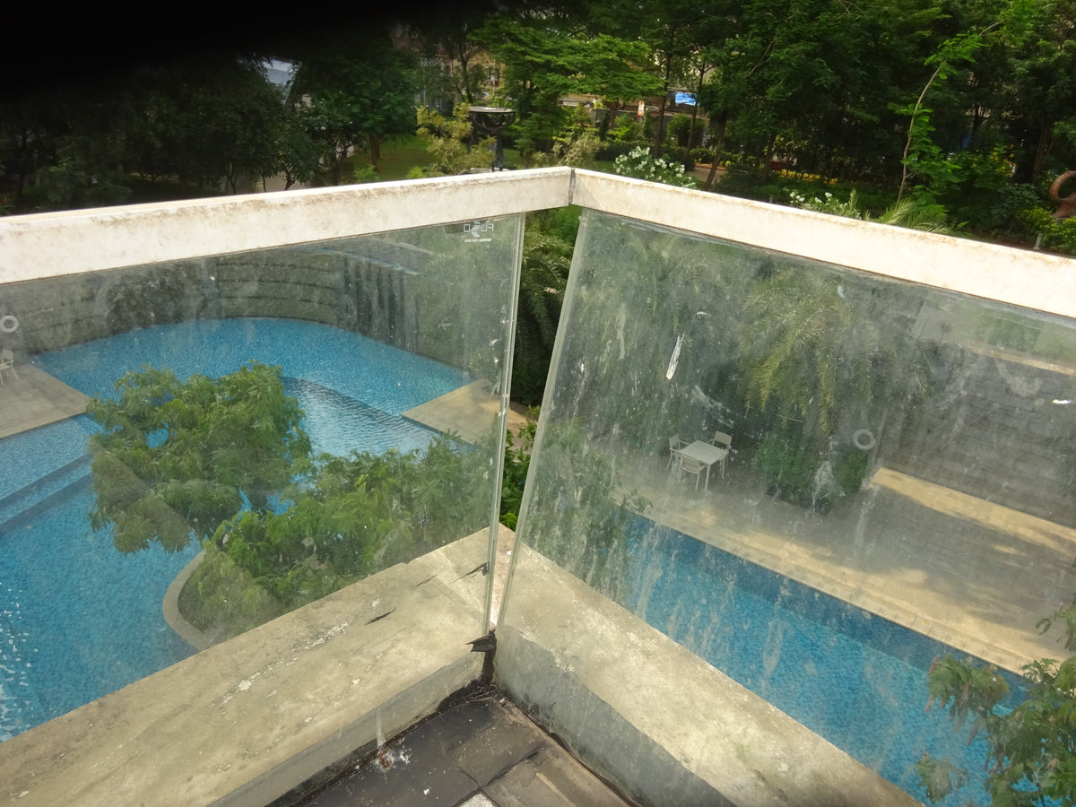 Glass curtain wall frame showing alignment and movement-related façade defects