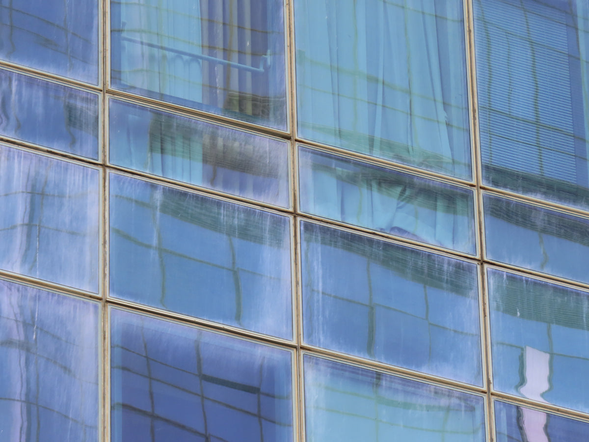 Condensation and moisture visible on glass façade panels